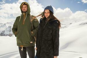 young beautiful hipster couple hiking in mountains photo