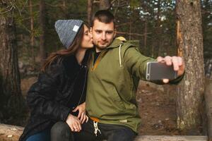 young beautiful hipster couple hiking in mountains photo