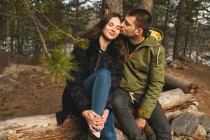 young beautiful hipster couple hiking in mountains photo