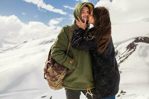 young beautiful hipster couple hiking in mountains photo