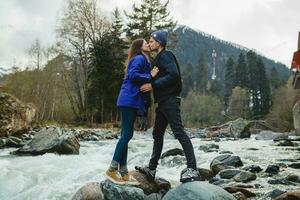 young hipster couple in love on winter vacation in mountains photo