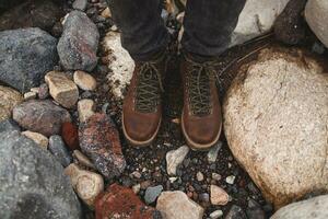 young hipster man hiking in mountains, winter vacation photo