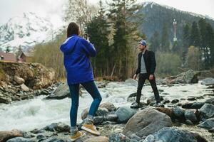 young hipster couple in love on winter vacation in mountains photo