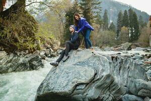 young hipster couple in love on winter vacation in mountains photo