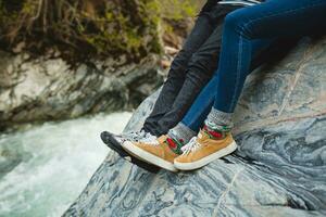 young hipster couple on winter vacation legs close-up photo