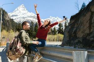 young hipster couple in love on winter vacation in mountains photo