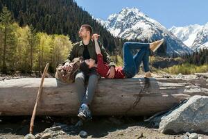 young hipster couple in love on winter vacation in mountains photo