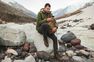 young hipster man hiking, traveling, backpacker photo