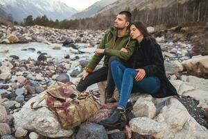 young beautiful hipster couple hiking in mountains photo