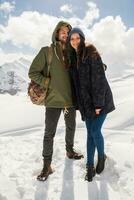 young beautiful hipster couple hiking in mountains photo