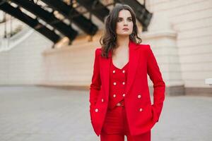 beautiful sexy rich business style woman in red suit walking in city street, spring summer fashion trend photo