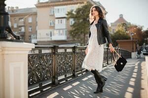 attractive woman walking in street in fashionable outfit photo