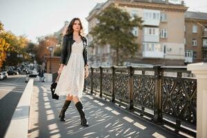 attractive woman walking in street in fashionable outfit photo