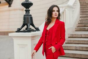 beautiful sexy rich business style woman in red suit walking in city street, spring summer fashion trend photo