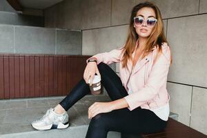 young beautiful stylish hipster woman in pink leather jacket photo