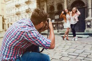 young handsome hipster man walking with photo camera