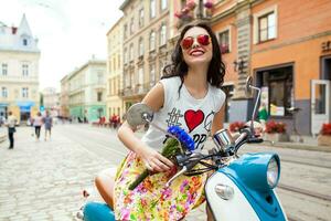 young beautiful woman riding on motorbike city street photo
