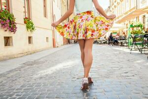 young beautiful hipster woman walking on old city street photo
