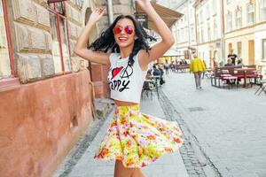 young beautiful hipster woman walking on old city street photo