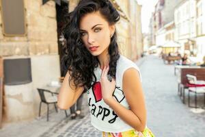 young beautiful hipster woman walking on old city street photo