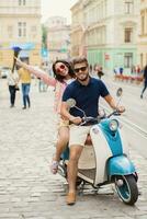 young beautiful hipster couple riding on motorbike city street photo