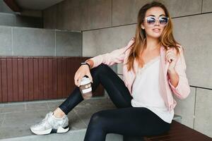 young beautiful stylish hipster woman in pink leather jacket photo