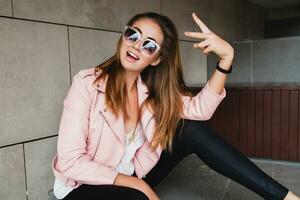 young beautiful stylish hipster woman in pink leather jacket photo