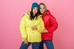 pretty women friends in colorful down jacket photo