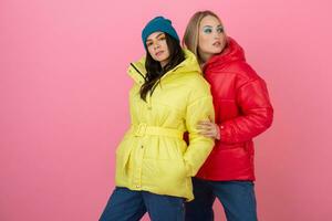 pretty women friends in colorful down jacket photo