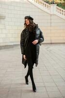 stylish woman in winter autumn fashion trend black puffer coat photo