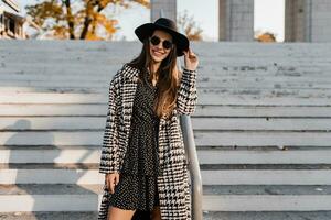 attractive young woman walking in autumn wearing coat photo