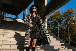 attractive young woman walking in autumn wearing coat photo