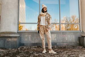 young smiling woman walking in street in winter photo