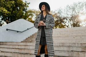 attractive young woman walking in autumn wearing coat photo