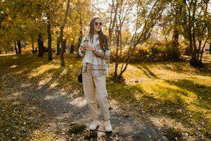 attractive young woman walking in autumn wearing jacket photo