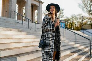 attractive young woman walking in autumn wearing coat photo