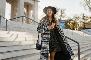 attractive young woman walking in autumn wearing coat photo