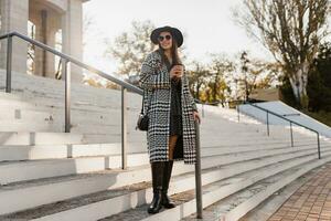 attractive young woman walking in autumn wearing coat photo