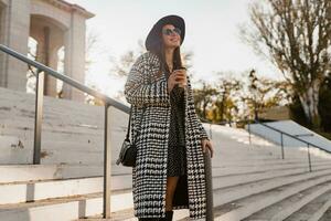 attractive young woman walking in autumn wearing coat photo