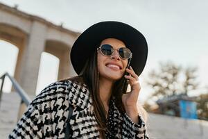 attractive young woman walking in autumn wearing coat photo