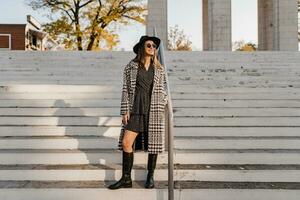 attractive young woman walking in autumn wearing coat photo