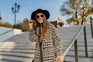 attractive young woman walking in autumn wearing coat photo