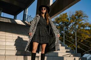 attractive young woman walking in autumn wearing coat photo