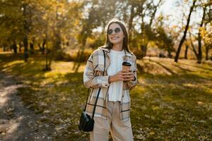 attractive young woman walking in autumn wearing jacket photo