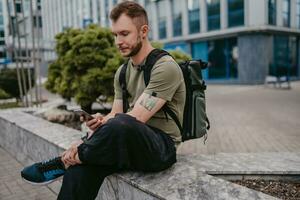 handsome hipster man walking in street photo