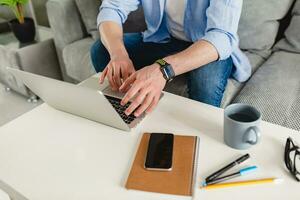 flat lay view from above on table workplace close-up man hands at home working photo