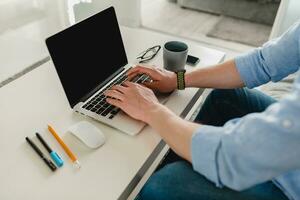 flat lay view from above on table workplace close-up man hands at home working photo