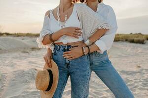 two young women having fun on the sunset beach photo