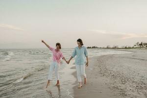 two young women having fun on the beach photo