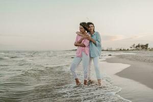 two young women having fun on the beach photo